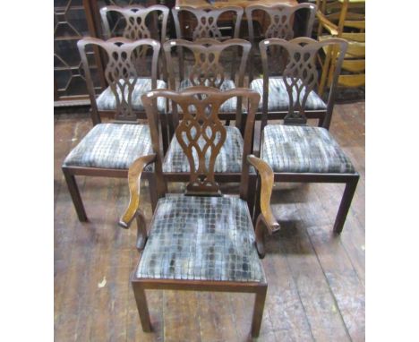 A set of seven (6&amp;1) Edwardian mahogany dining chairs in a Chippendale manner, carved and pierced splats, upholstered sea