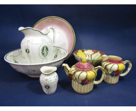 A collection of HJ Wood wares with floral moulded detail comprising a circular fruit bowl, a tea pot and a milk jug, together