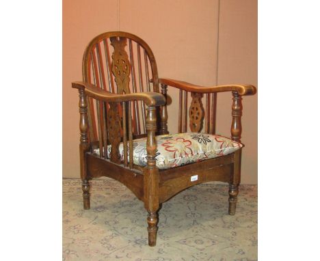 A Windsor stained elm and beechwood hoop and stick back elbow chair with pierced splat, together with a further hoop and stic