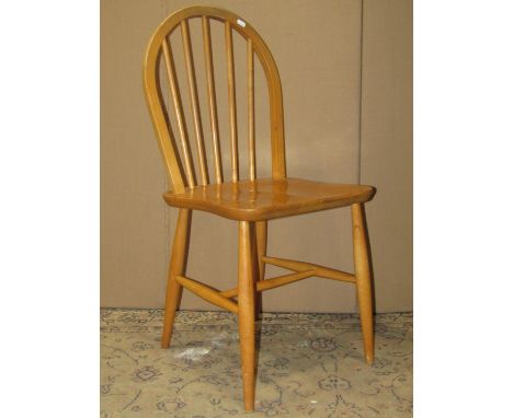 A set of three Ercol light elm and beechwood hoop and stick back dining chairs with simple turned supports and stretchers 