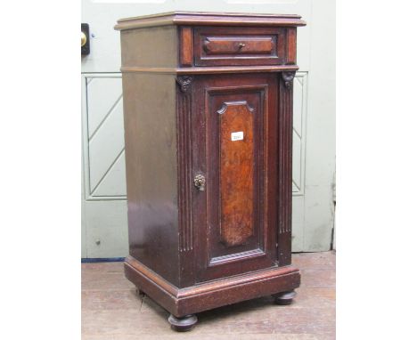 19th century bedside/lamp cabinet enclosed by a panelled door and a frieze drawer with reeded detail on bun feet (AF) 