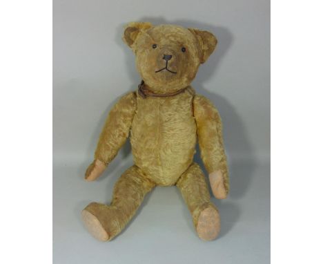 A good old teddy bear, circa 1930's  with boot button eyes, stitched nose and mouth, clipped pronounced nose and humped back,