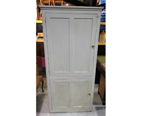 An old painted pine kitchen/housekeepers cupboard enclosed by two panelled doors with shelved interior and light green painte