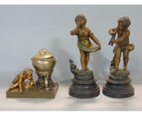 Good quality ormolu and spelter novelty ink well in the form of a boy lighting a fire under a cauldron, 15 cm long 