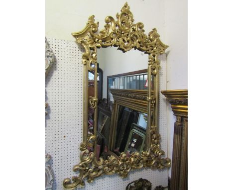 A large Chippendale style wall mirror with carved C scroll acanthus and broken arch frame, 137 cm x 91 cm 