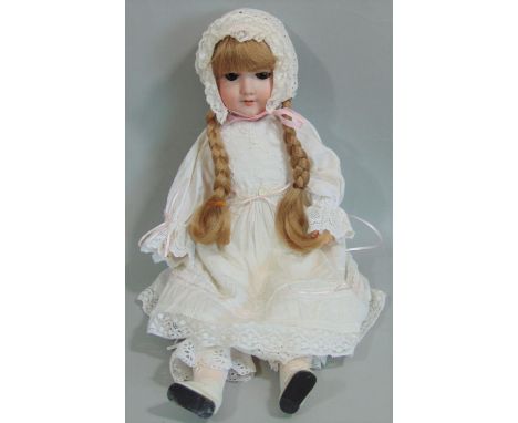 Armand Marseille doll mold 390 with a bisque socket head and with stick legs on a jointed composition body. Long fair hair, b