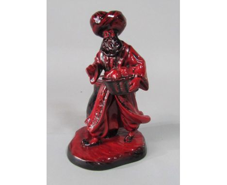 A Royal Doulton Flambe figure of the Lamp Seller HN3278 