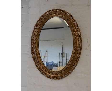 Gilt framed oval wall mirror