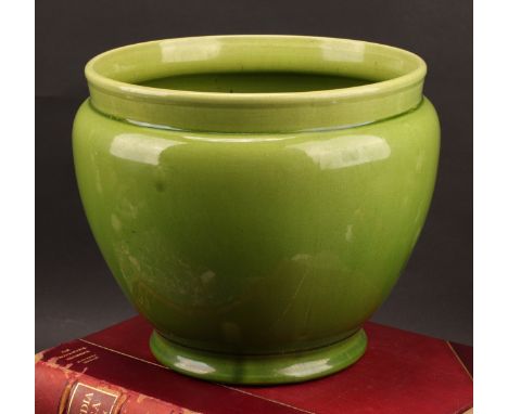 A Holdcroft art pottery ovoid jardinière, glazed in tones of mottled green, 23cm high