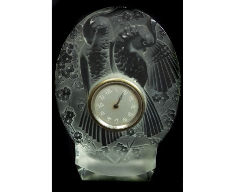 A Etling glass parakeet pattern clock, ovoid form on plinth base, moulded with two birds amid prunus blossom, movement marked