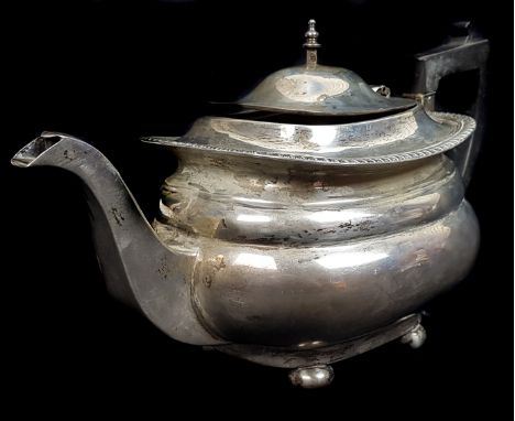 A silver teapot of stepped bombe form on four flattened ball feet, Sheffield 1920, makers mark JD over WD for James Deakins &