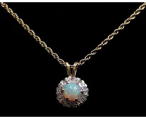 An 18ct gold opal and diamond cluster ring, ring size K 1/2; and an 18ct carat gold opal and diamond pendant 7 grms (2)