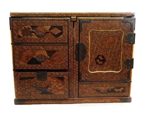 A Japanese parquetry scholars desk cabinet, composed of two cabinets, one containing three drawers, the other with single dra