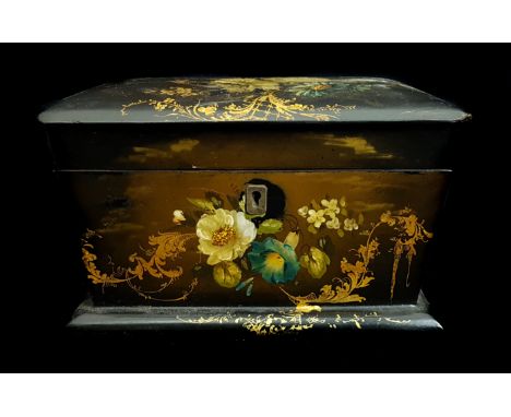 A Victorian paper mache tea caddy, casket form, painted with summer flowers, with gilded trellis and sprays, the hinged lid r