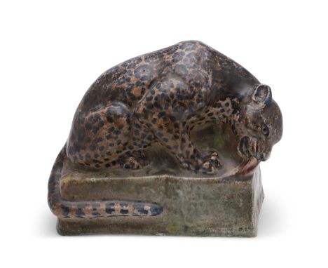 STELLA CROFTS (1898-1964) - LARGE POTTERY CHEETAH. A large pottery figure of a Cheetah eating a piece of meat, the animal sea