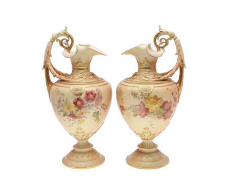 LARGE PAIR OF ROYAL WORCESTER EWERS. A pair of blush ivory ewers, with acanthus shaped handle and the neck with foliage in re