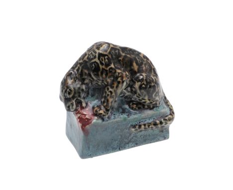 STELLA CROFTS (1898-1964) - POTTERY LEOPARD. A small stoneware figure of a Leopard eating it's prey, the figure painted and o