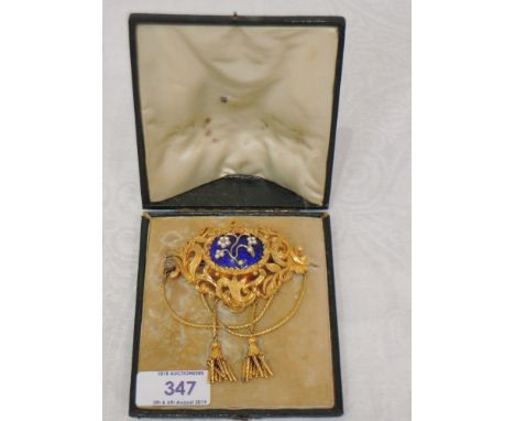A large ornate yellow metal mourning/hair locket brooch having central blue enamel panel with seed pearl and diamond chip flo