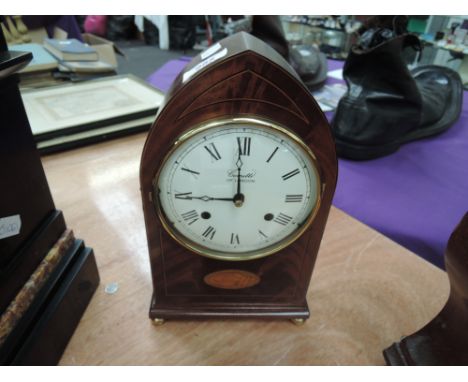 A modern mahogany mantel clock of Edwardian design by Comitti of London, having inlay decoration and brass detail