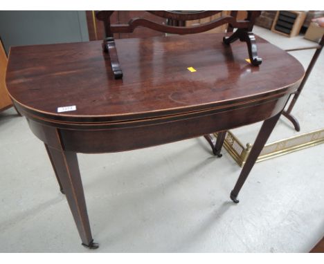 An early 19th century mahogany tea table having D fold over top and tapered gate legs