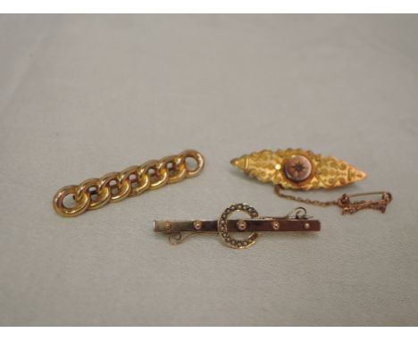 Three 9ct gold bar brooches of various forms having moulded, seed pearl and diamond chip decoration.&nbsp; APPROX 5.9G