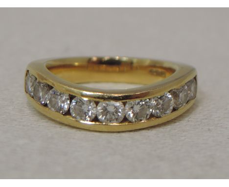 A lady's half eternity ring having nine channel set brilliant cut diamonds, approx 0.50ct in a shaped 18ct gold loop, size I