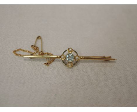 A yellow metal bar brooch stamped 15ct having central topaz and seed pearl decorationAPPROX 3.9G