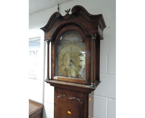 A late 18th century oak longcase clock having swan neck and pillar hood, containing square brass dial with additional painted