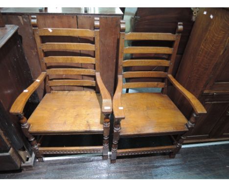 A pair of 20th century oak and craftsman made armchairs having ladder backs with solid seats and bulbous legs