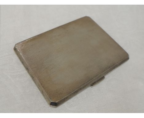 A silver cigarette case of rectangular form having engine turned chequered decoration and gilt wash interior, Birmingham 1960