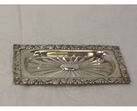 A small silver trinket tray having star burst decoration and a moulded scroll rim, Birmingham, date mark worn