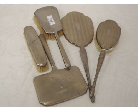 Five HM silver dressing table brushes and hand mirrors, (2 &amp; 3) having engine turned decoration and plain cartouches (som