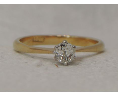 A lady's dress ring having an old cut diamond solitaire, approx 0.20ct in a claw set mount to tapered shoulders on yellow met