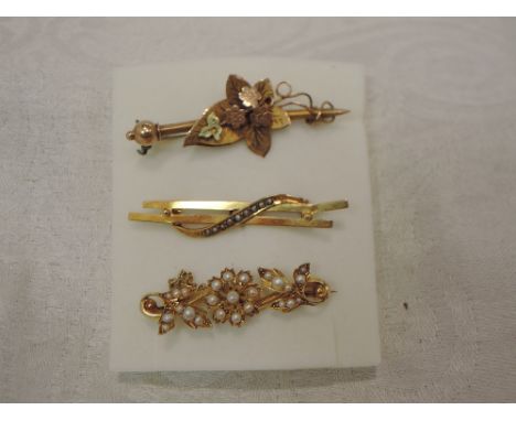A yellow metal bar brooch stamped 15ct having seed pearl floral decoartion, another similar having seed pearl wave decoration