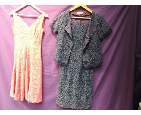 Two beautiful 1950s lace dresses, one in bright pink with V neckline and flared skirt, the other in navy blue with matching j