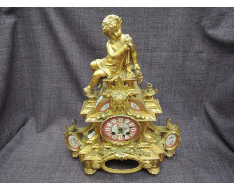 A 19th century mantel clock of ormolu style French design having cherub, mask and sevres panel influence decoration having ci