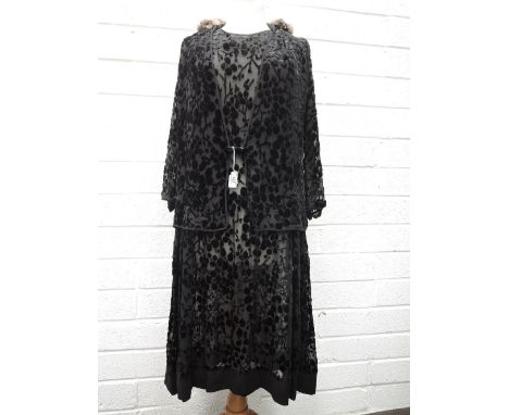 An antique 1930s long sleeved dress with dropped waist and gathers to shoulders and waist. flocked velvet detailing throughou