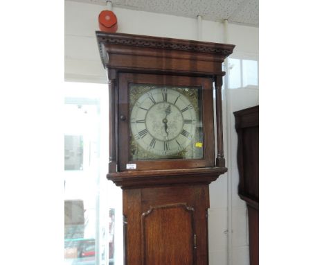 A late 18th century oak longcase clock having square pillar hood containing brass and silvered face and 30 hour movement by B