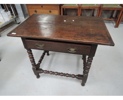 A composite 19th and 20th century oak side table in the Jacobean style having frieze drawer and bobbin frame