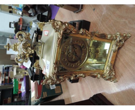 A 19th century brass case American mantel clock by Ansonia Clock Co, having roccoco style scroll fruit and urn finial with ci