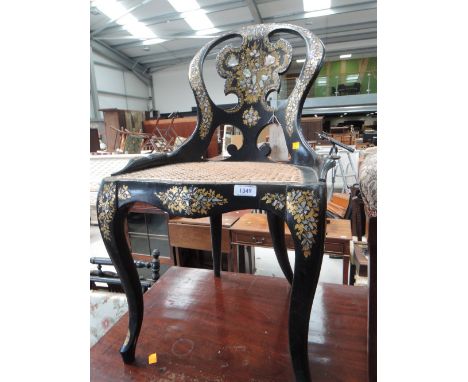 A Victorian papier mache chair in the style of Jennens &amp; Bettridge having mother of pearl inlay decoration and later cane