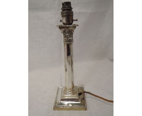 A Victorian silver Corinthian column candlestick on a stepped square base with beaded decoration, later converted to an elect