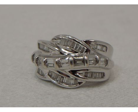 A lady's dress ring having a baguette diamond set stylised twist, total approx 0.7ct on a white metal loop stamped 18K,  size