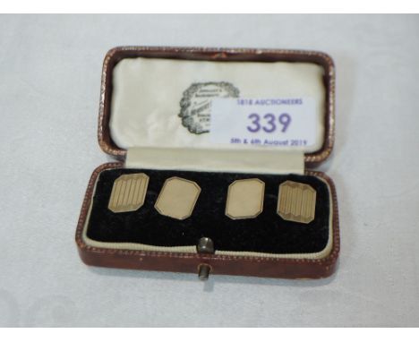 A pair of 9ct gold cufflinks of rectangular form having engine turned decoration and chain connectors.&nbsp; APPROX 4G