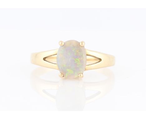 A 9ct yellow gold opal ring, claw set with an oval opal cabochon, measuring approx. 7x9mm, hallmarked Birmingham 2006, ring s