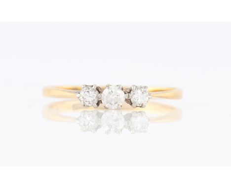 A three stone diamond ring, set with three diamonds, two being old cut and one round brilliant cut, total diamond weight appr