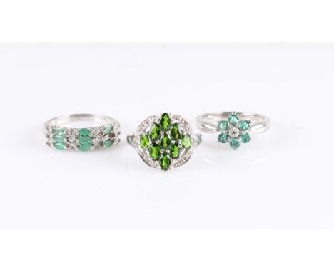 Three rings set with green stones in various designs, all stamped 925, ring size O, (A/F one stone missing).