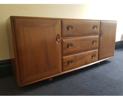 An Ercol elm sideboard.