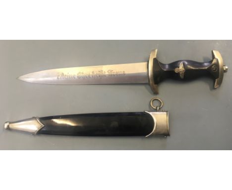 A SS Nazi German dagger with black painted handle marked with RZM M7/36 to blade.