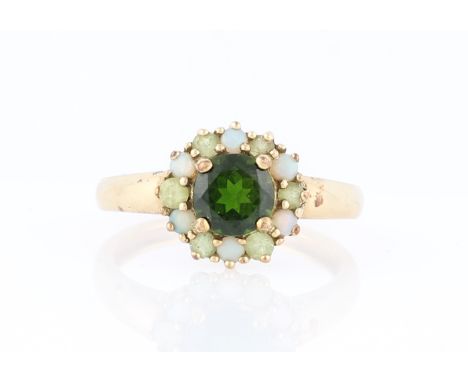 A 9ct yellow gold green chrome diopside and opal ring, claw set with a central round cut green chrome diopside, measuring app